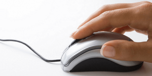 A hand clicking a mouse